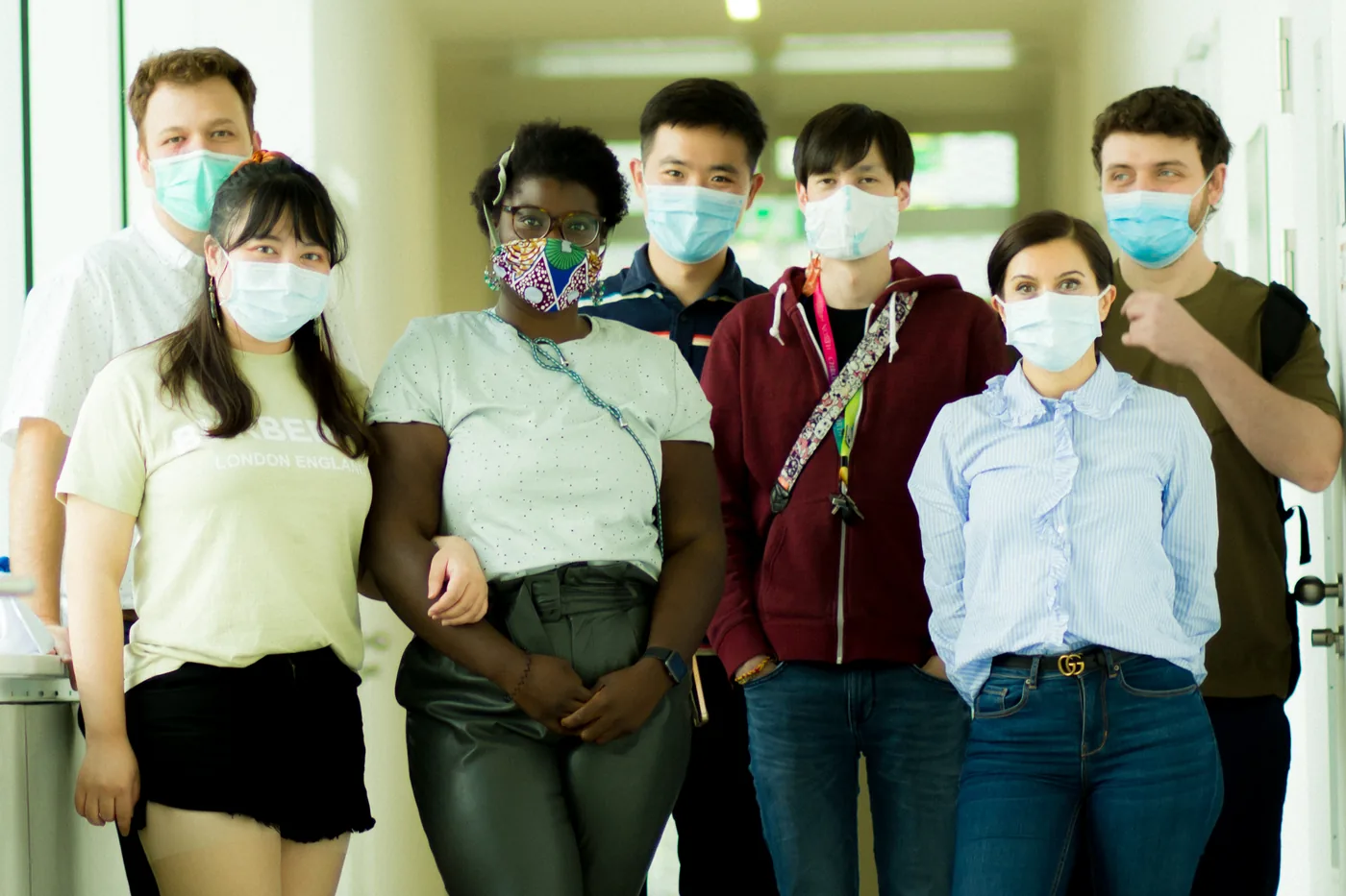 The lab group together in the corridor of the institute